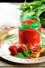 Strawberry smoothie on wooden table background