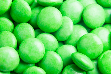 Close up on pile green milk chocolate candies crisp shell