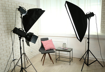 Photo studio with modern interior and lighting equipment
