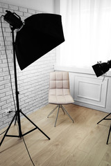 Photo studio with modern interior and lighting equipment