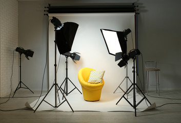 Photo studio with modern interior and lighting equipment