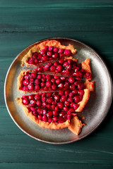 Tart with raspberries on tray, on wooden background