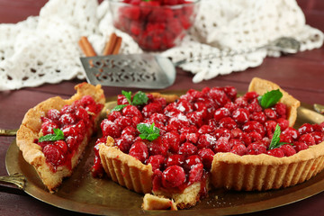 Piece of tart with raspberries on tray, close-up