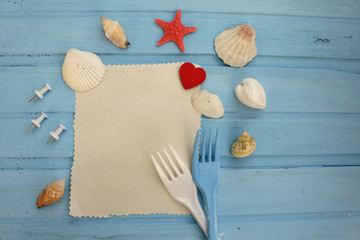 Fancy sea food concept menu with copy space for text - fork, shells, fish star and paper 
