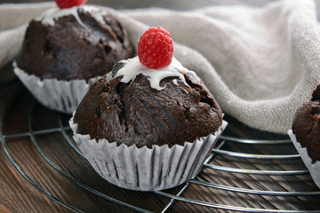 Delicious cupcakes with berries on table close up