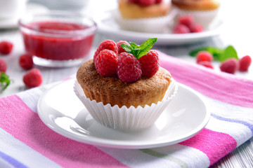 Delicious cupcake with berries and fresh mint on table close up