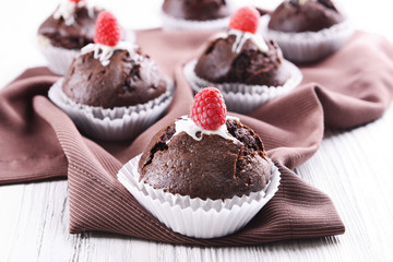 Delicious cupcakes with berries on table close up