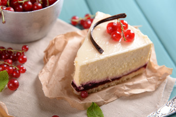 Tasty cheesecake with berries on table close up