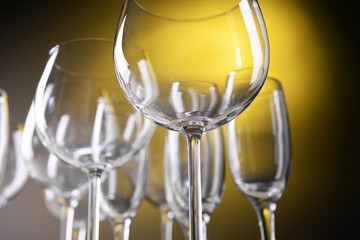 Empty wine glasses on yellow background