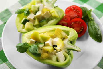 Fresh green salad in pepper on table close up