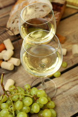 Still life of wine and bread on rustic wooden background