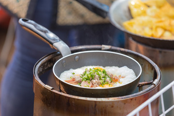 Frying sausages and scrambled eggs in fat.