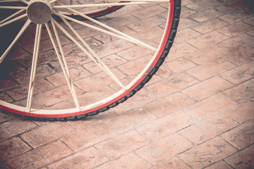 vintage filter,close up wagon wheel on stone pavement