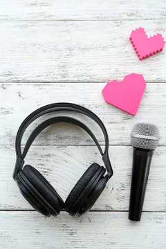 headphones and microphone on wooden background
