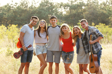 A photo of happy friends relaxing in the forest outdoors