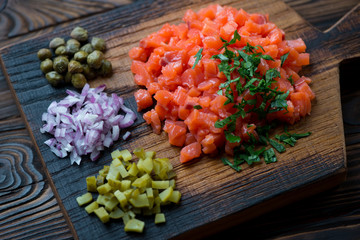 Salmon tartare with onion, pickles, capers and fresh parsley
