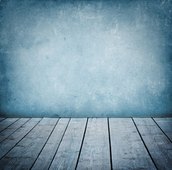 Grunge wall and wood paneled floor, interior of a room.
