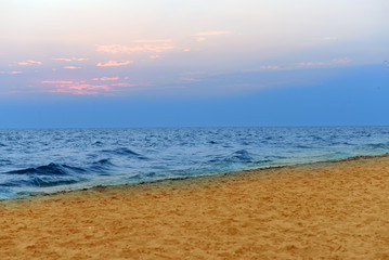 Fototapeta na wymiar Sea shore, waves and sky at sunset