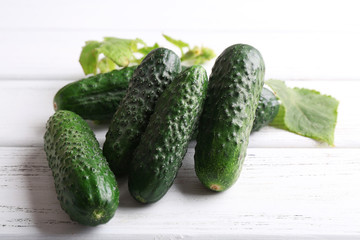 Cucumbers on light wooden background