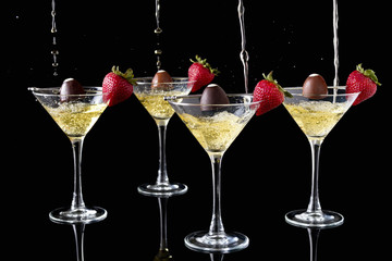 Champagne Pouring Onto Chocolate Truffles With Strawberries