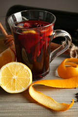 Beautiful composition of traditional mulled wine with decorations on the table