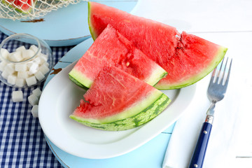 Sliced watermelon on white plate