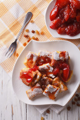 Kaiserschmarrn with plum sauce closeup on a plate. vertical top view
