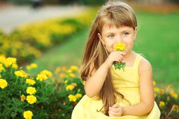 Little girl with flowers outside