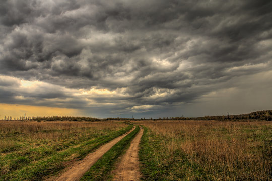 dirt road going into the eye of the storm.