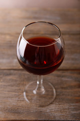 Glass of red wine on wooden table