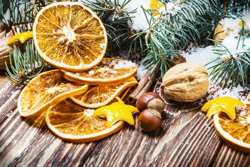 Fototapeta na wymiar dried oranges with nuts and fir branches