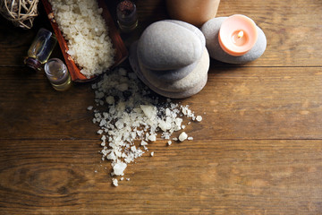 Beautiful relax composition with candles and pebbles on wooden background, close up