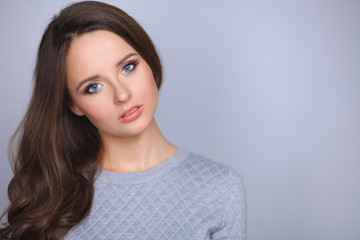 Fototapeta premium Portrait of an attractive fashionable young brunette woman