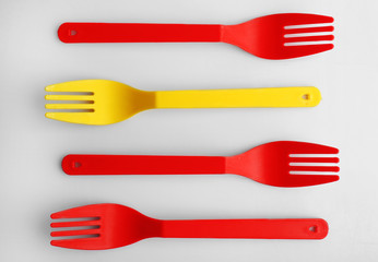 Disposable colourful forks isolated on white, top view, Individuality concept