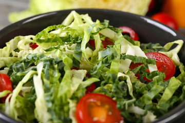 Savoy cabbage and tomato salad served in bowl closeup