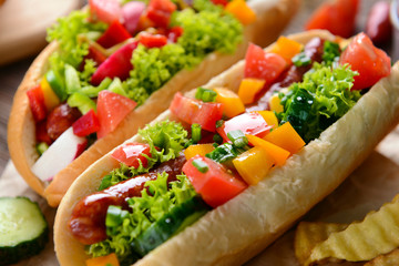 Hot dogs and vegetables on craft paper closeup