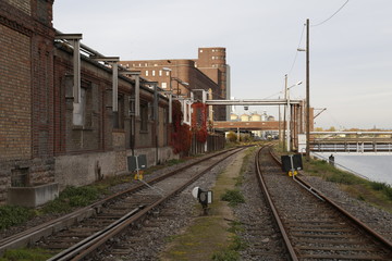 Fototapeta premium industrial lost place with railway by a river