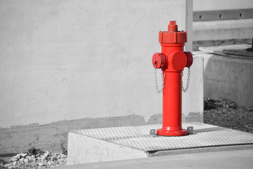 Fire hydrant long a construnction site, black and white effect