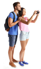 A pair of happy tourists sightseeing in summer, isolated on white