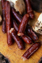 Grilled sausages on cutting board in the wood