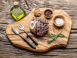 Beef steaks  with spices on a wooden tray.
