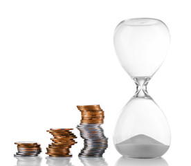 Hourglass with coins isolated on white