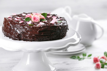 Chocolate cake decorated with flowers on the table