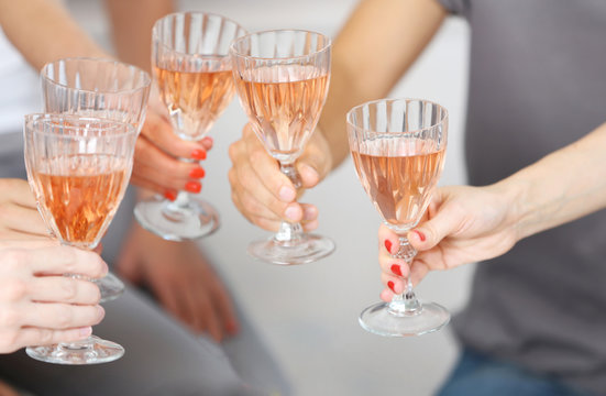 Friends Hands With Glasses Of Pink Wine, Close Up