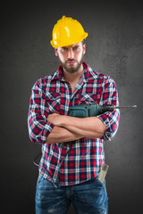 Attractive young workman with drill
