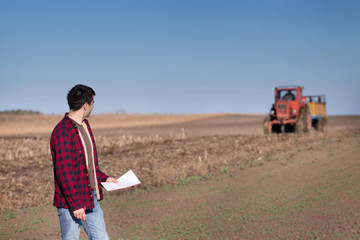 Farmer with tractor on field