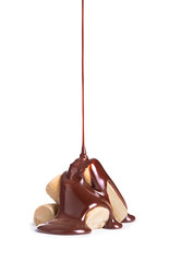melted chocolate is poured on a stack of milk caramel sweets
