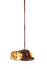 melted chocolate is poured on nuts caramel
