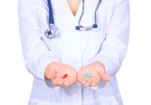 Doctor's hands holding two pills