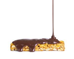 melted chocolate is poured on nuts isolated on white